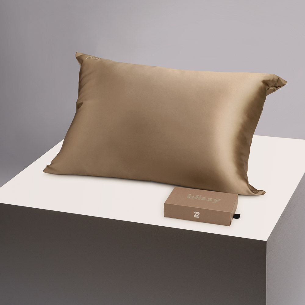 Blissy taupe pillowcase on a table