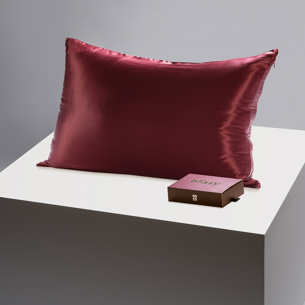 Blissy burgundy pillowcase on a table