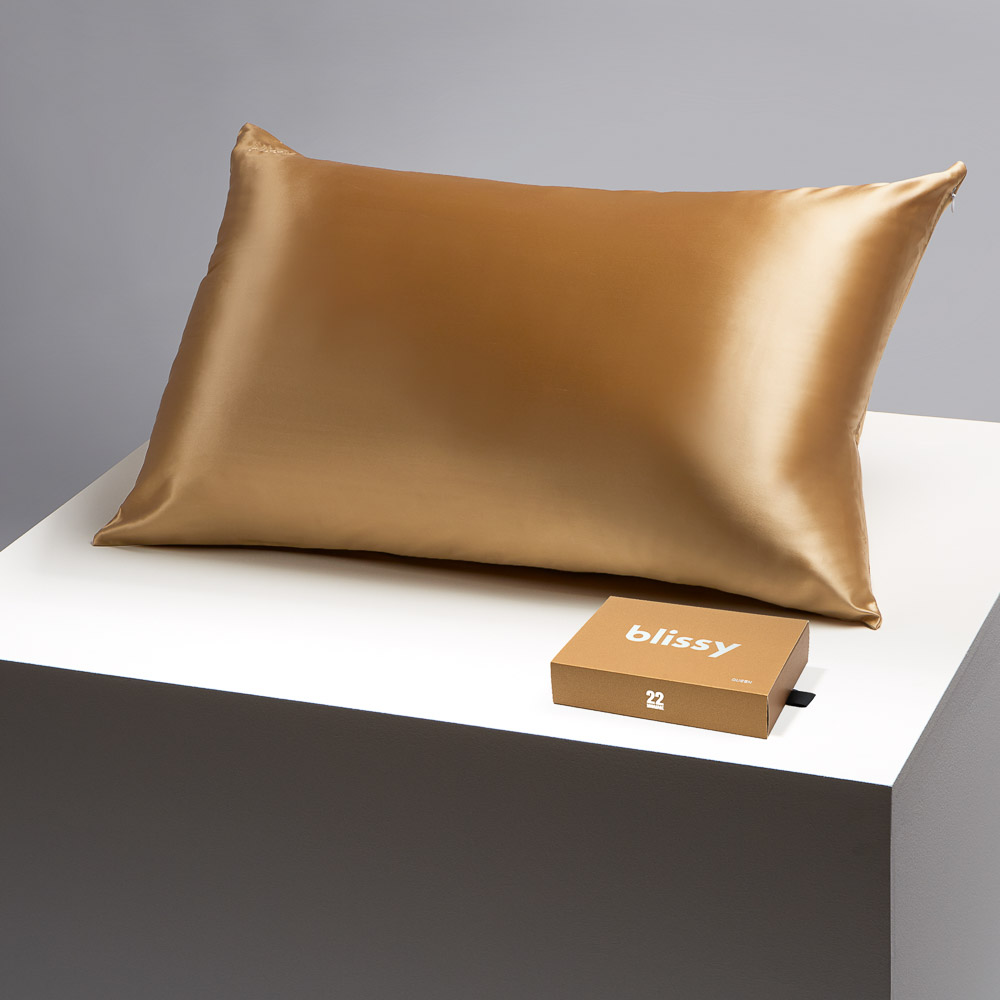 Blissy gold pillowcase on a table