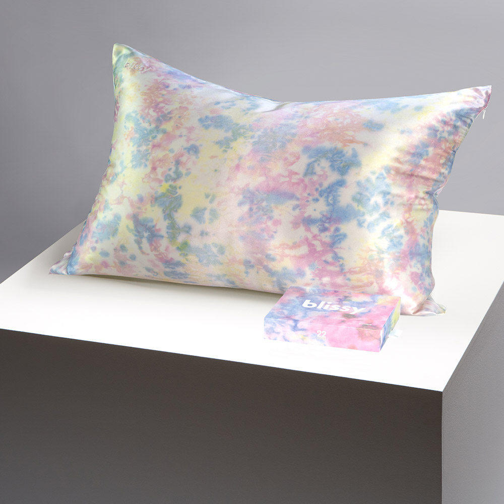 Blissy yellow tie dye pillowcase on a table