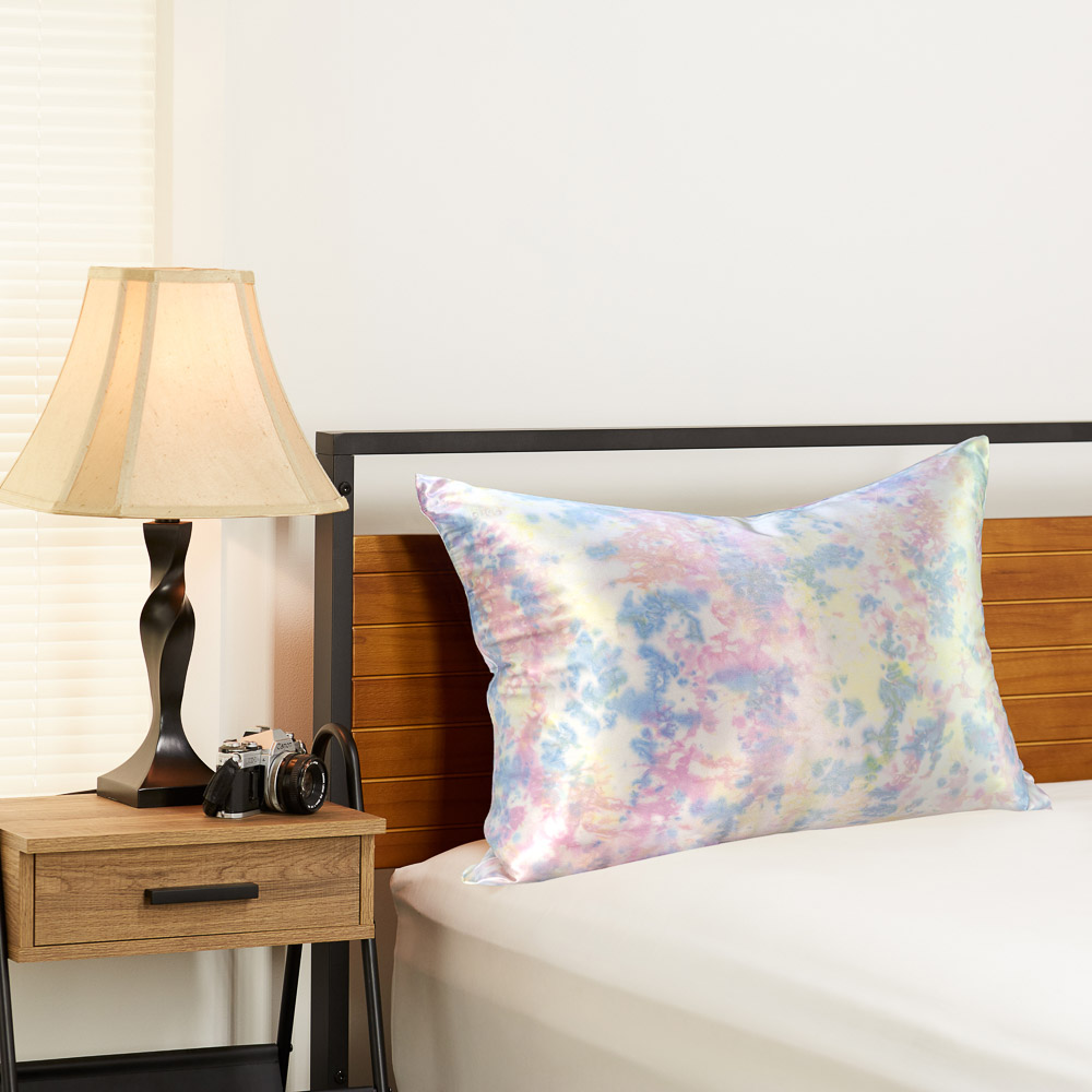 Tie dye yellow Blissy silk pillowcase in a bedroom