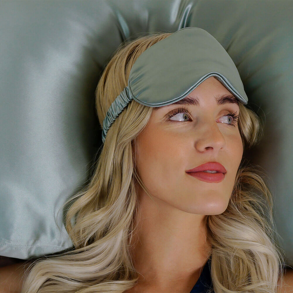 Woman lying down on a matcha Blissy silk pillowcase