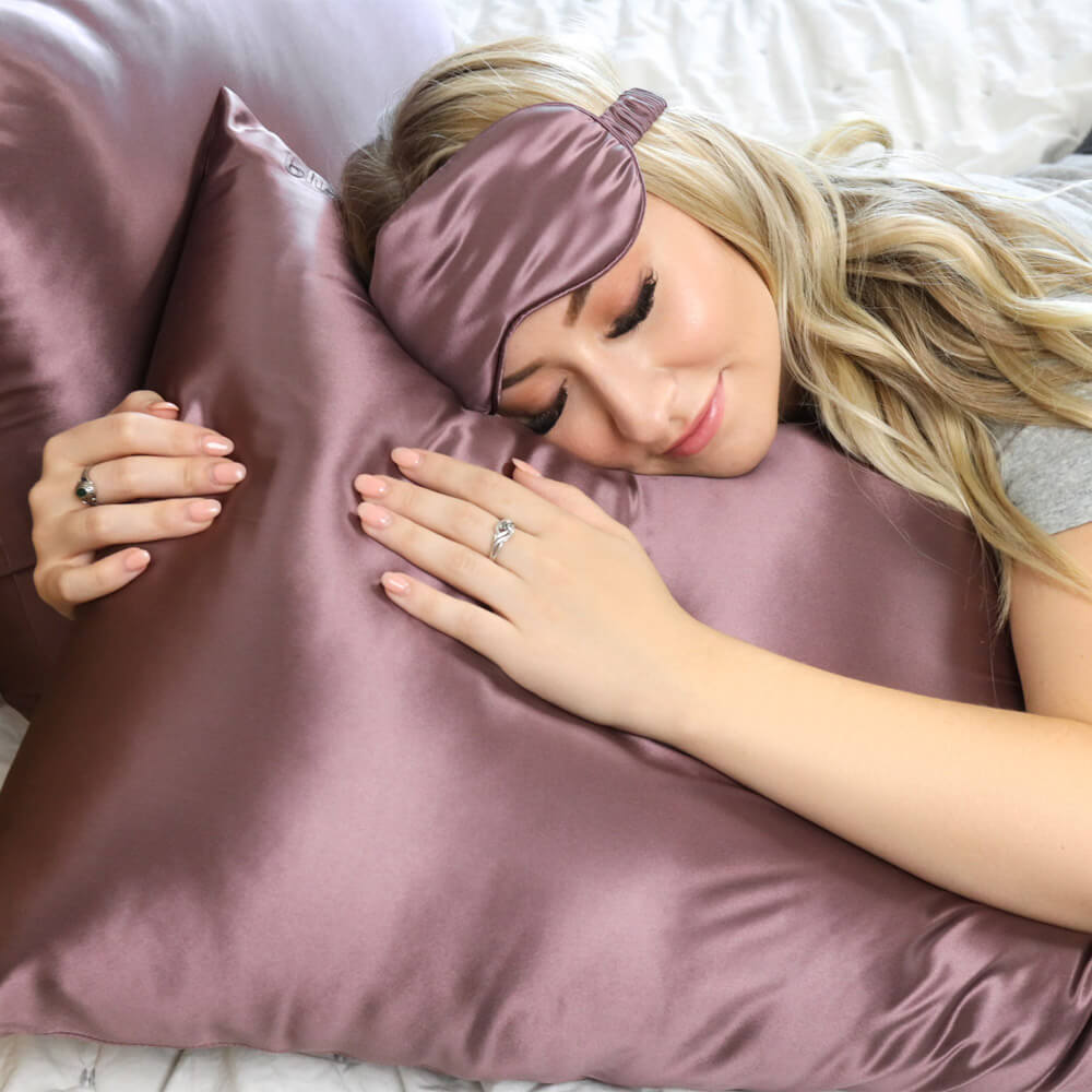Woman sleeping on a plum Blissy silk pillowcase