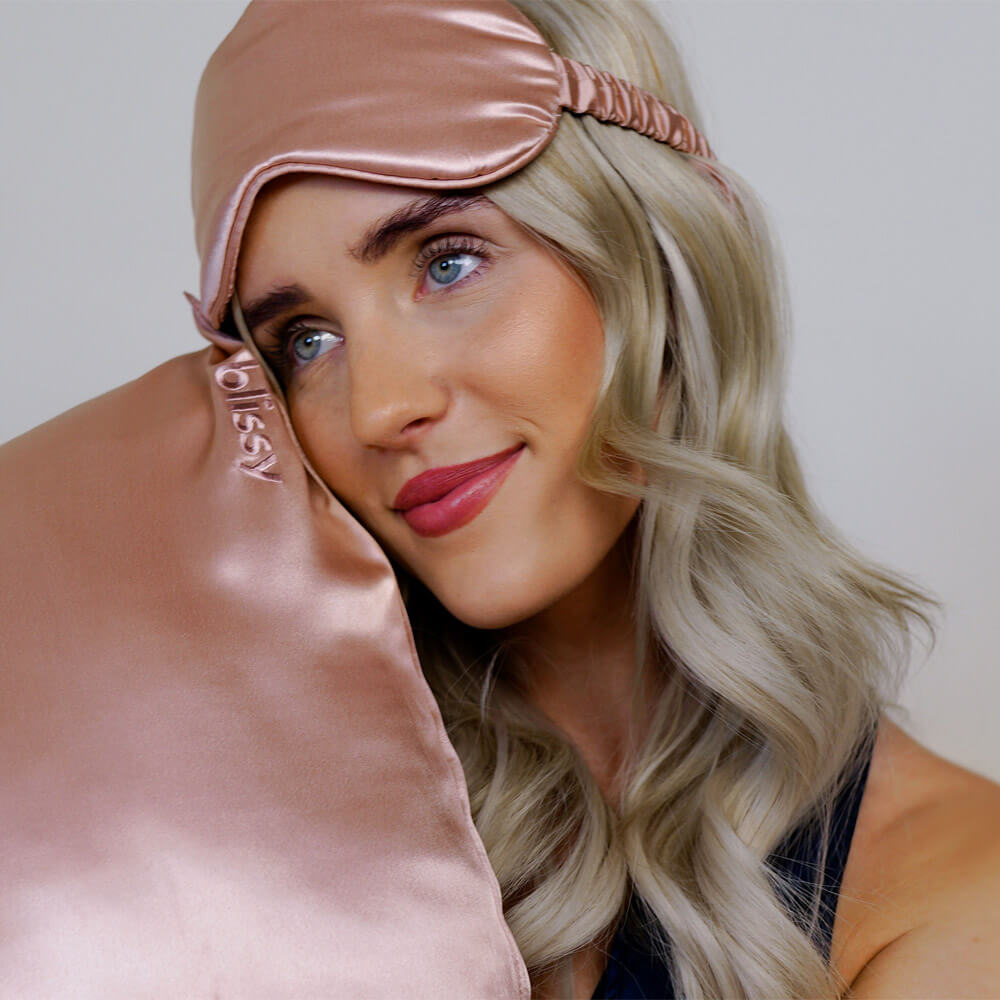 Woman holding a rose gold Blissy silk pillowcase