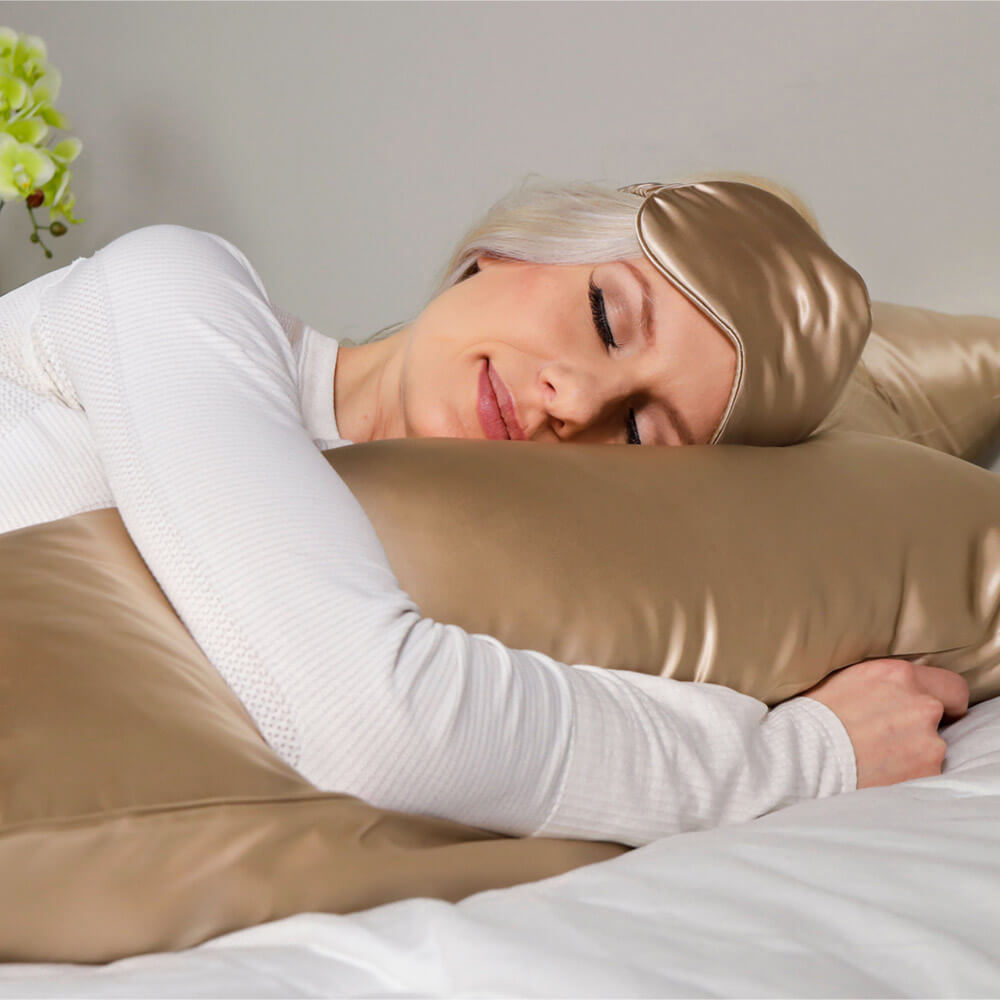 Woman sleeping on a taupe Blissy silk pillowcase